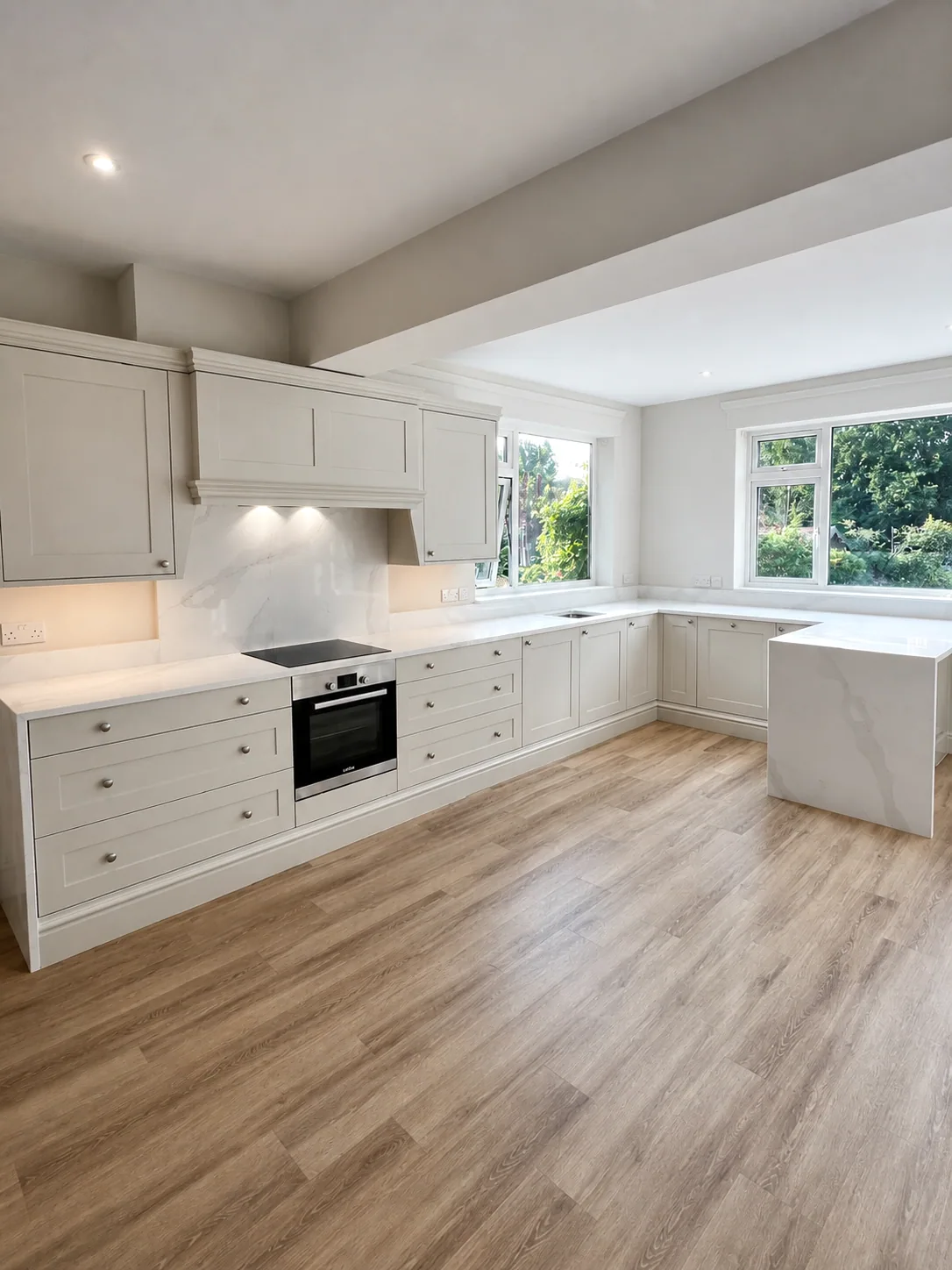 Bespoke painted shaker kitchen wrapping around a bright family room